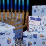Chanukah Candles And Dad Grass and Mom Grass Stash Gift Packs On Wrapping Paper