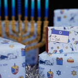 Chanukah Candles And Dad Grass and Mom Grass Stash Gift Packs On Wrapping Paper