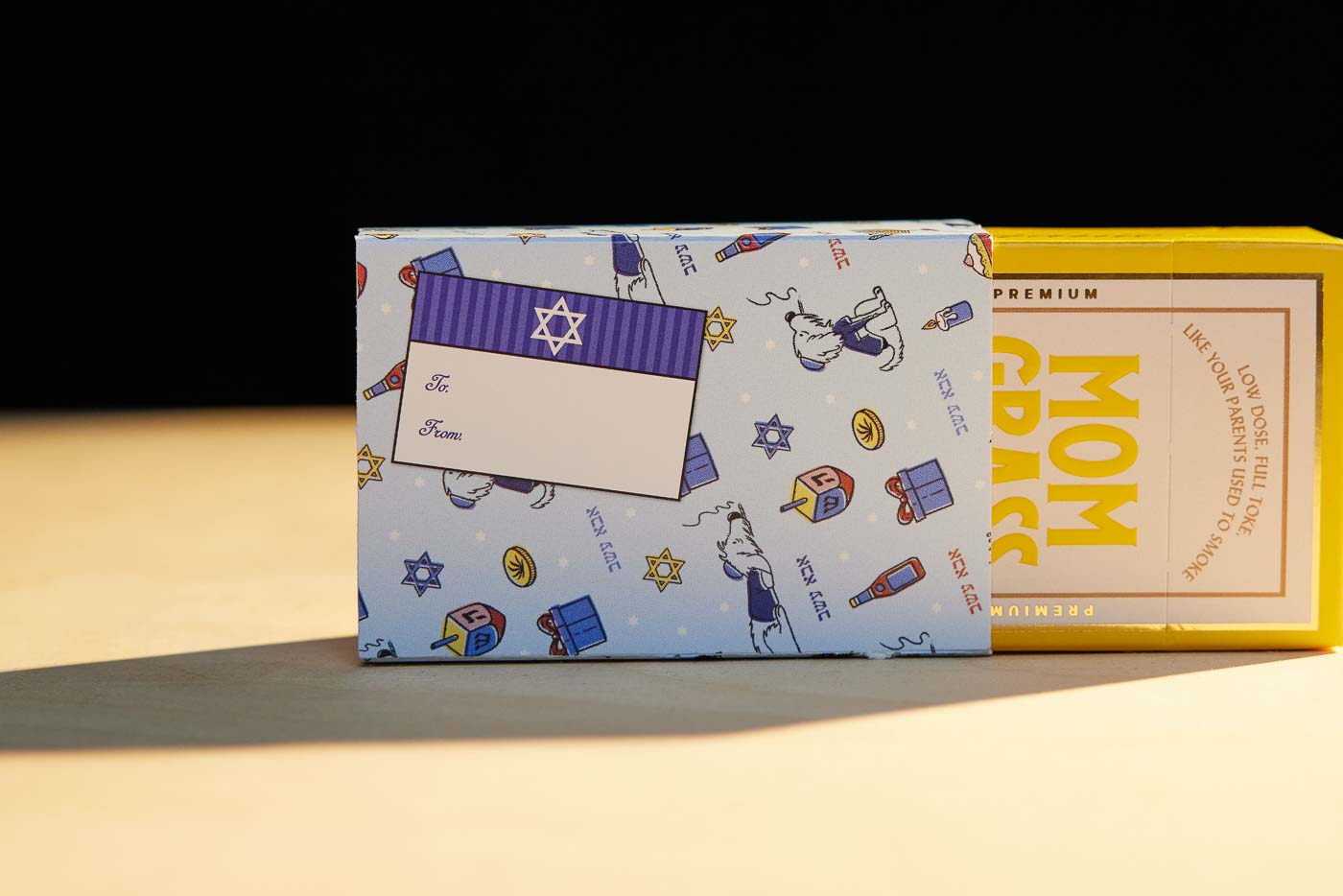 Mom Grass Stash Pack Coming Out From A Chanukah Gift Wrapping Paper