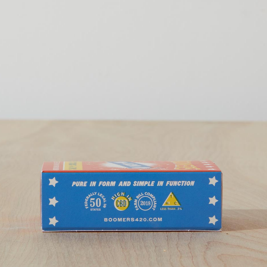 Dad Grass 5 pack hemp CBD pre rolls in Boomers firework sleeve bottom view with "PURE IN FORM AND SIMPLE IN FUNCTION" written on it