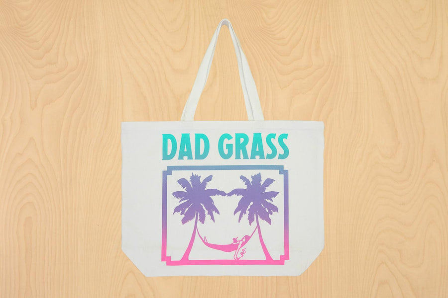 Dad Grass x Free & Easy Summer 2021 white unisex pool tote bag on wooden table