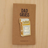 Mom Grass Pack Pin on cardboard on a wooden table