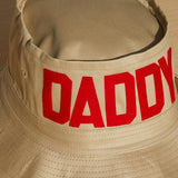 Dad Grass Pride 2021 tan bucket hat, front view from above says "Daddy"