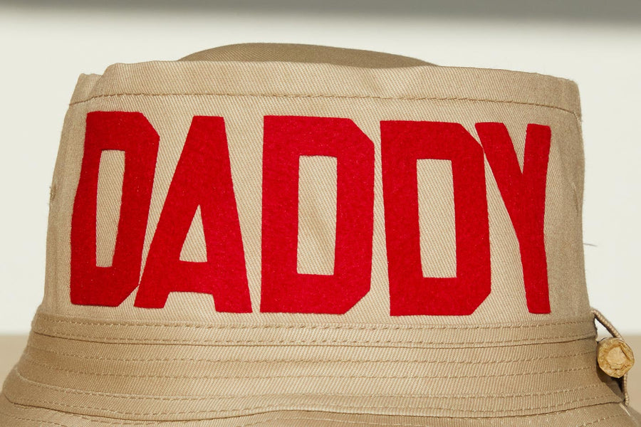 Dad Grass Pride 2021 tan bucket hat, close up view of front word "Daddy"