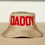 Dad Grass Pride 2021 'DADDY CHILL'  tan bucket hat. Front view says 'DADDY'