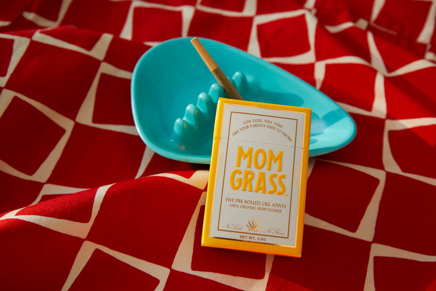 Mom Grass hemp CBG preroll 5 pack with a hemp flower joint in a ashtray