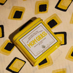 Yellow Mom Grass CBG Hemp Flower Tin On A Yellow Cloth