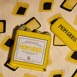 Yellow Mom Grass CBG Hemp Flower Tin On A Yellow Cloth