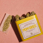 CBG Hemp Flower Coming Out From A Yellow Tin With Crushed CBG On A Rolling Paper