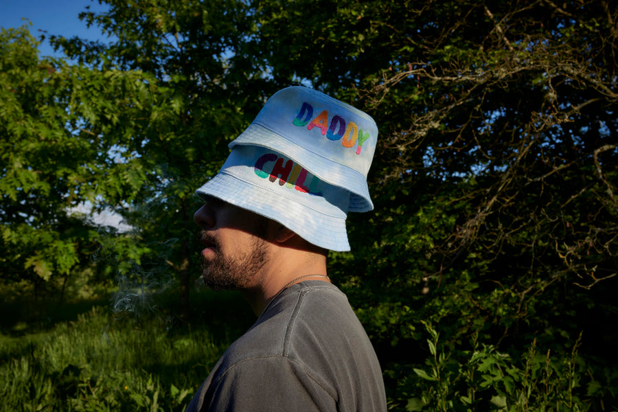 Man Wearing "Daddy Chill" Pride 2022 Bucket Hat - Dad Grass