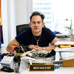 Mark McNairy Sitting On His Office With Best Dad Ever Name Plate
