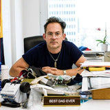 Mark McNairy Sitting On His Office With Best Dad Ever Name Plate