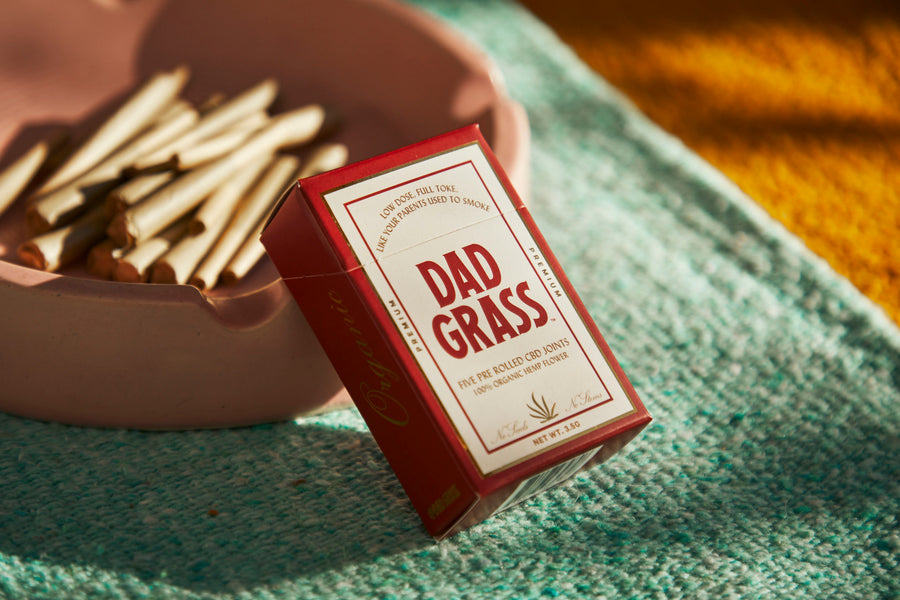 Dad Grass hemp CBD preroll 5 pack with hemp flower joints in a ashtray
