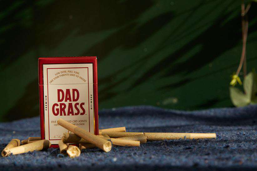 Dad Grass Hemp CBD Pre Roll Joints 5 Pack On A Blue Carpet