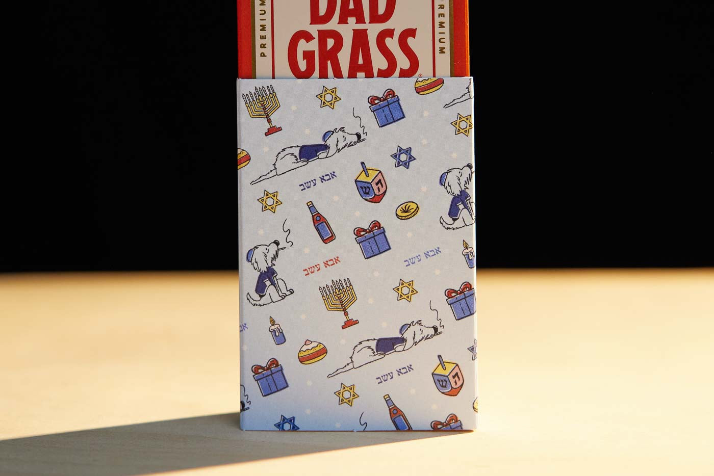 Dad Stash Pack Coming Out From A Chanukah Gift Wrapping Paper 