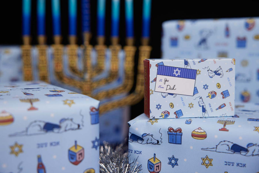 Chanukah Candles And Dad Grass and Mom Grass Stash Gift Packs On Wrapping Paper