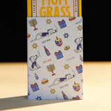 Mom Grass CBG Pre Roll Joints Pack Coming Out From A Chanukah Gift Wrapping Paper 