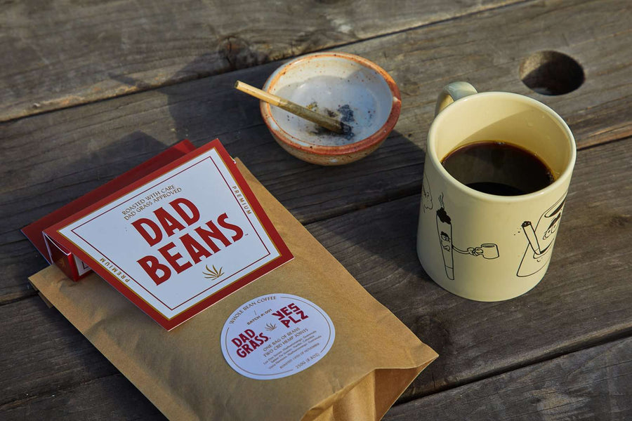 Dad Grass x Yes Plz Coffee beans with hemp cbd joints on ashtray and coffee filled mug