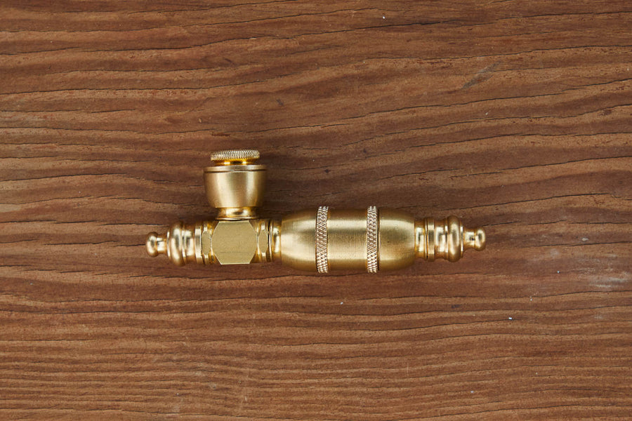 Dad Grass brass steamroller vintage smoking pipe on a wooden surface 