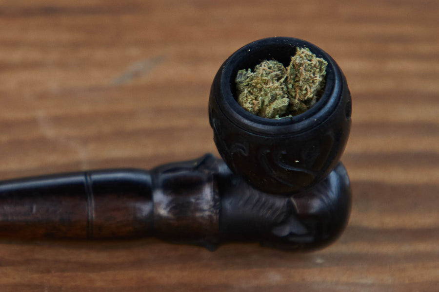 Dad Grass carved ebony vintage smoking pipe with hemp CBD flower close view