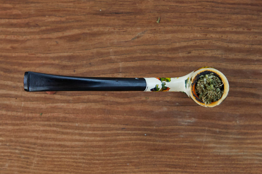 Dad Grass painted half bent billiard vintage smoking pipe with hemp CBD flower top view