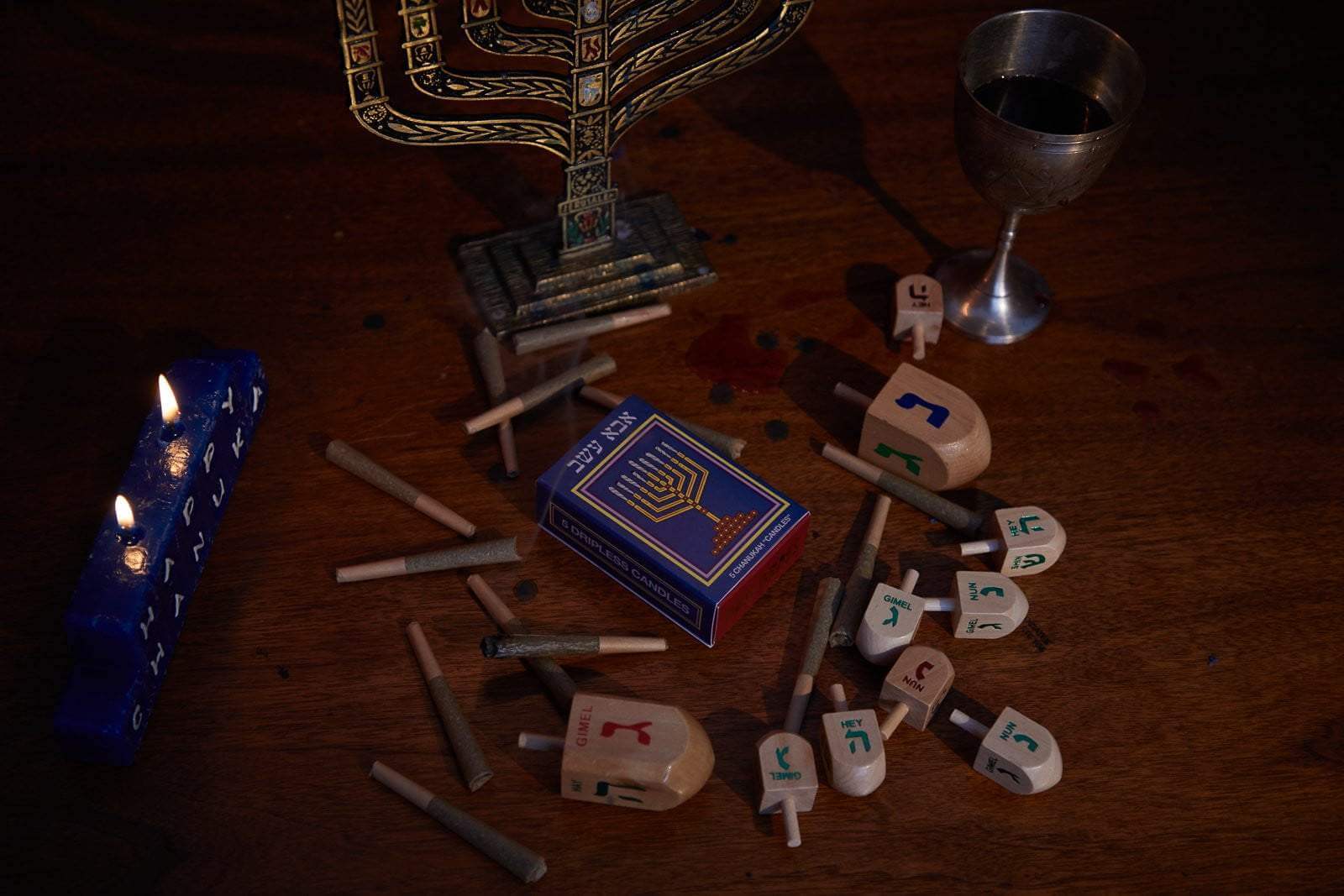 CBD Pre Roll Joints With Chanukah Candles, Happy Chanukah Sign and Glass