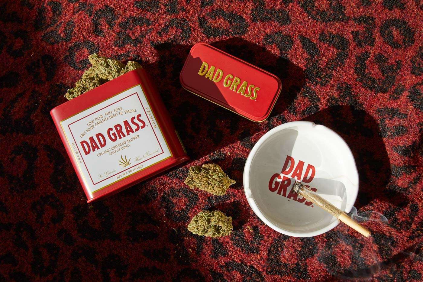 Dad Grass CBD Hemp Flower And CBD Joints On Red & Black Carpet