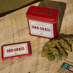 Dad Grass CBD hemp flower And Rolling Paper On A Wooden Table