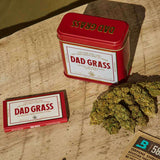 Dad Grass CBD hemp flower And Rolling Paper On A Wooden Table