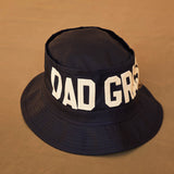 Black Bucket Hat With Dad Grass Written On It And CBD Pre roll On The Side Front View