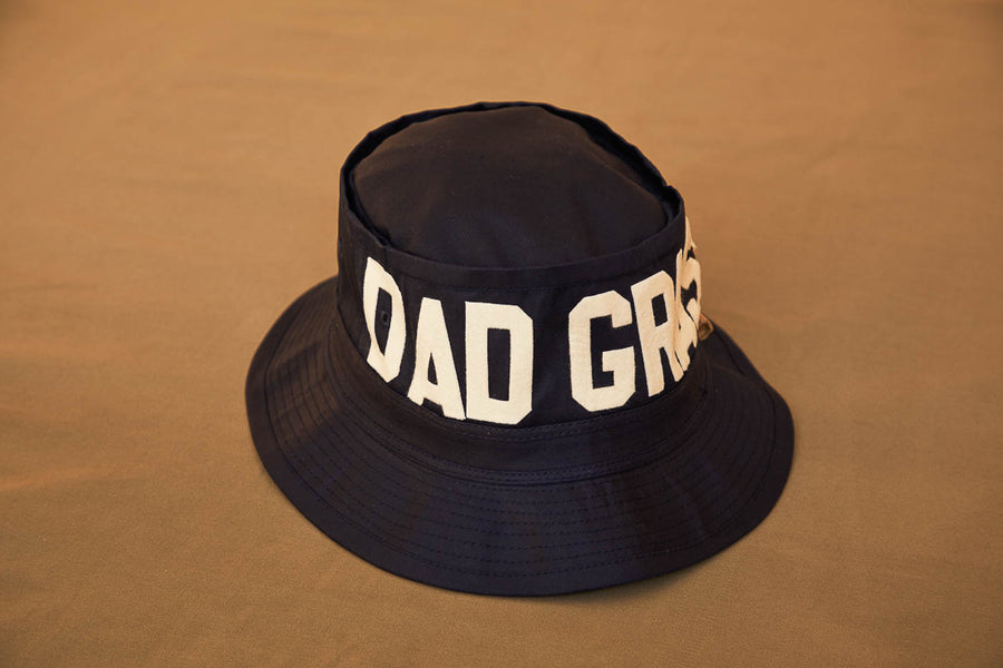 Black Bucket Hat With Dad Grass Written On It And CBD Pre roll On The Side Front View