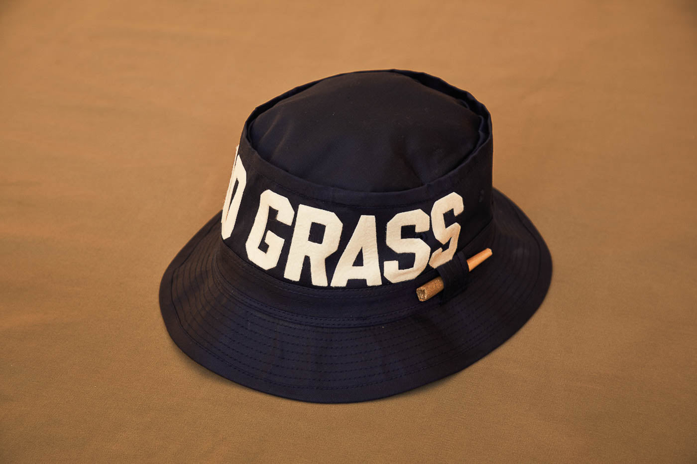 Black Bucket Hat With Dad Grass Written On It And CBD Pre roll On The Side