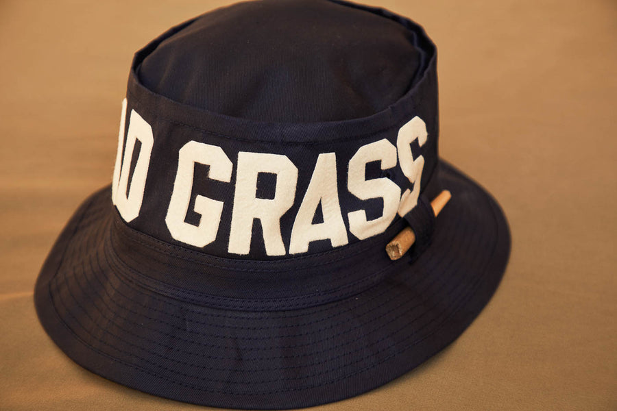 Black Bucket Hat With Dad Grass Written On It And CBD Pre roll On The Side Close Up