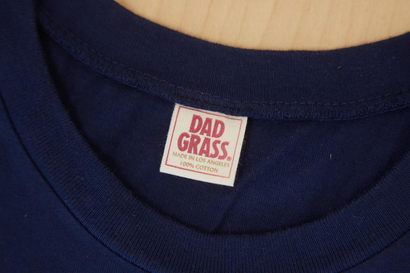 100% Cotton Label on "GRASS" Collegiate Unisex Tee