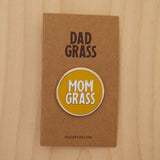 Mom Grass Circle Pin on cardboard on a wooden table