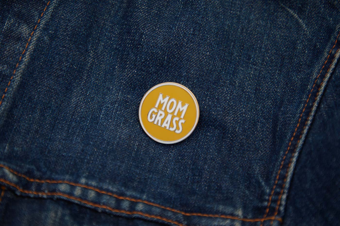 Mom Grass Circle Pin on a denim jacket