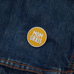 Mom Grass Circle Pin on a denim jacket
