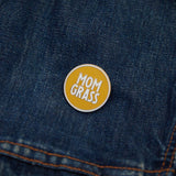 Mom Grass Circle Pin on a denim jacket