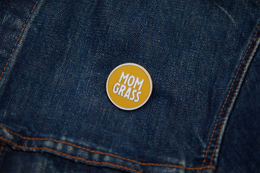 Mom Grass Circle Pin on a denim jacket