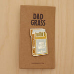 Mom Grass Pack Pin on cardboard on a wooden table