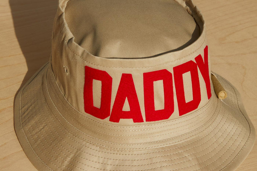 Dad Grass Pride 2021 tan bucket hat, front view from above says "Daddy"