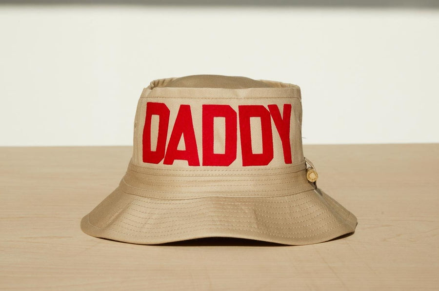 Dad Grass Pride 2021 'DADDY CHILL'  tan bucket hat. Front view says 'DADDY'
