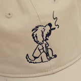 Dad Grass Cream White Dad Hat With Rollie Dog Smoking On It Close Up