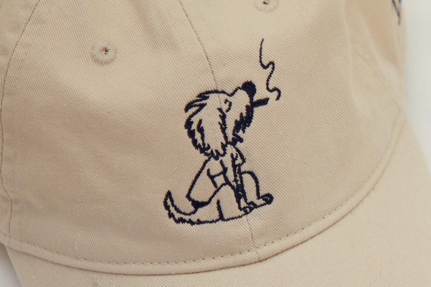 Dad Grass Cream White Dad Hat With Rollie Dog Smoking On It Close Up