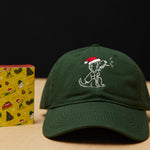 Dad Grass Dark Green Santa Rollie Dad Hat And CBD Pre Roll Joints In A Christmas Gift Wrapping Paper