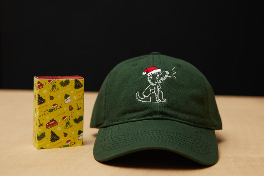Dad Grass Dark Green Santa Rollie Dad Hat And CBD Pre Roll Joints In A Christmas Gift Wrapping Paper