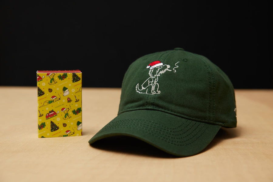 Dad Grass Dark Green Santa Rollie Dad Hat And CBD Pre Roll Joints In A Christmas Wrapping Paper