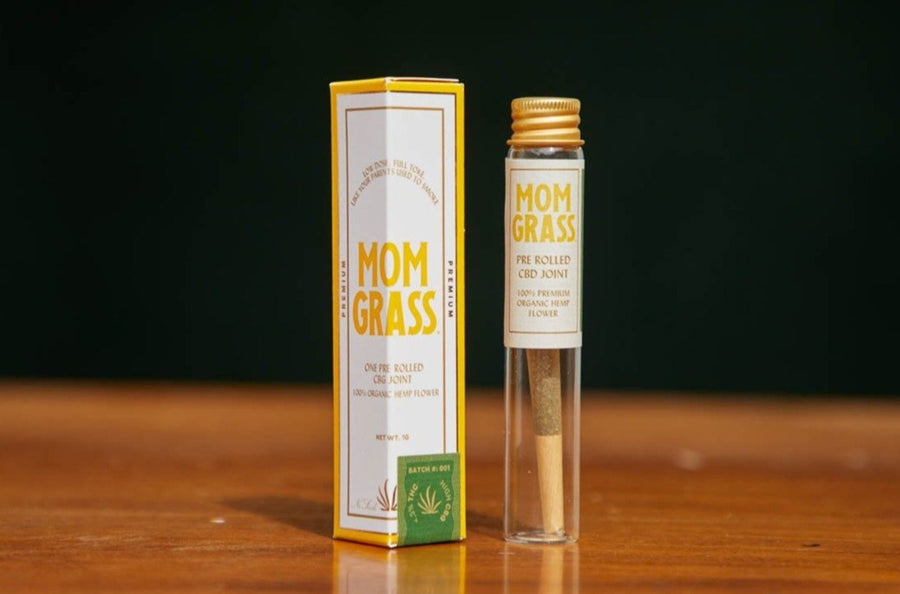 Mom Grass classic hemp CBG preroll inside a glass vial next to a hexagonal box