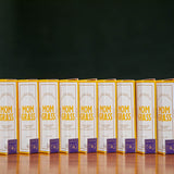 Boxes of Mom Grass hemp CBG joints lined up on a wooden table