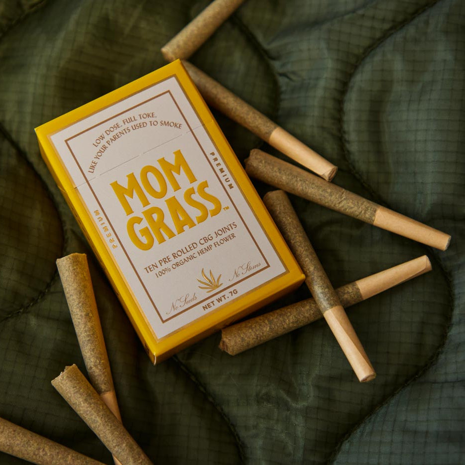 Pre rolls with 10 CBG Hemp Pre rolls in a Yellow Mom Grass pack on a sheet